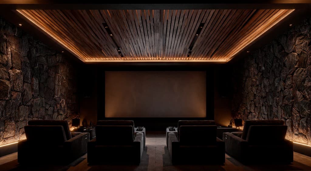 Luxury home theater with stone walls and warm ambient lighting